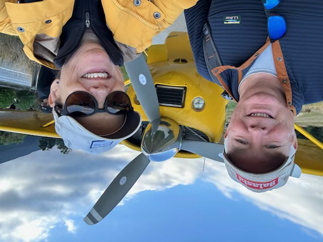 Steve and his wife in front of a helicopter