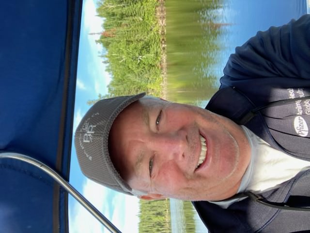 Steve taking a selfie on a boat on the lake