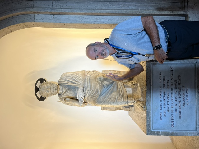 Peter in front of a statue